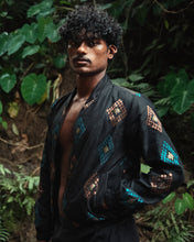 Load image into Gallery viewer, Man wearing a black embroidered jacket in a forest setting