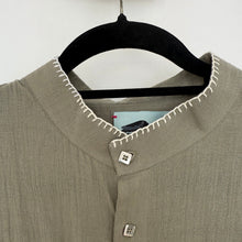 Load image into Gallery viewer, Close-up of a moss shirt with a collar and metal buttons on a white background