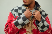Load image into Gallery viewer, Person wearing a colorful quilted jacket with a checkered pattern on a plain background