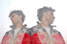 Load image into Gallery viewer, Person wearing a patterned jacket with a reflective surface
