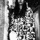 Person wearing a patterned dress sitting on a couch.