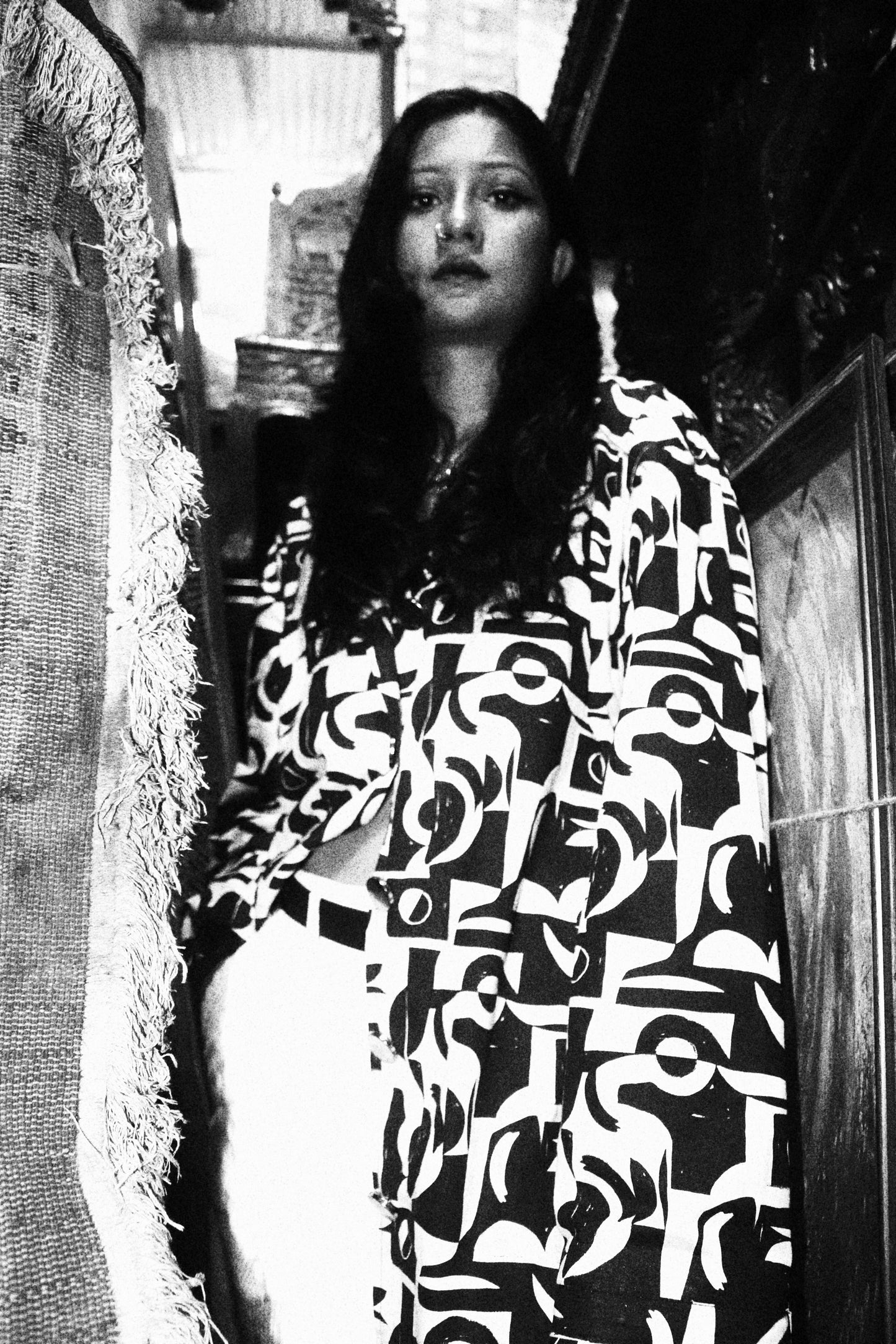 Person wearing a patterned dress sitting on a couch.