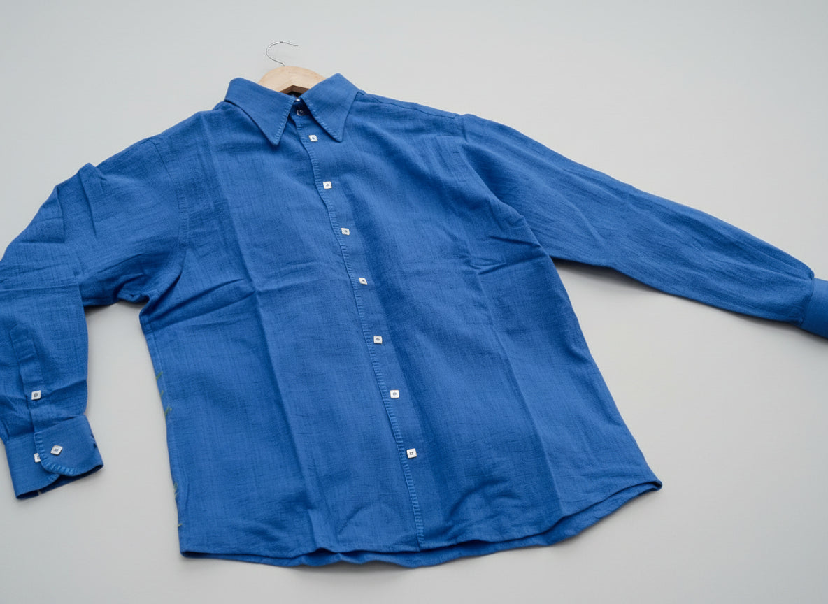 Blue shirt on a hanger against a grass background